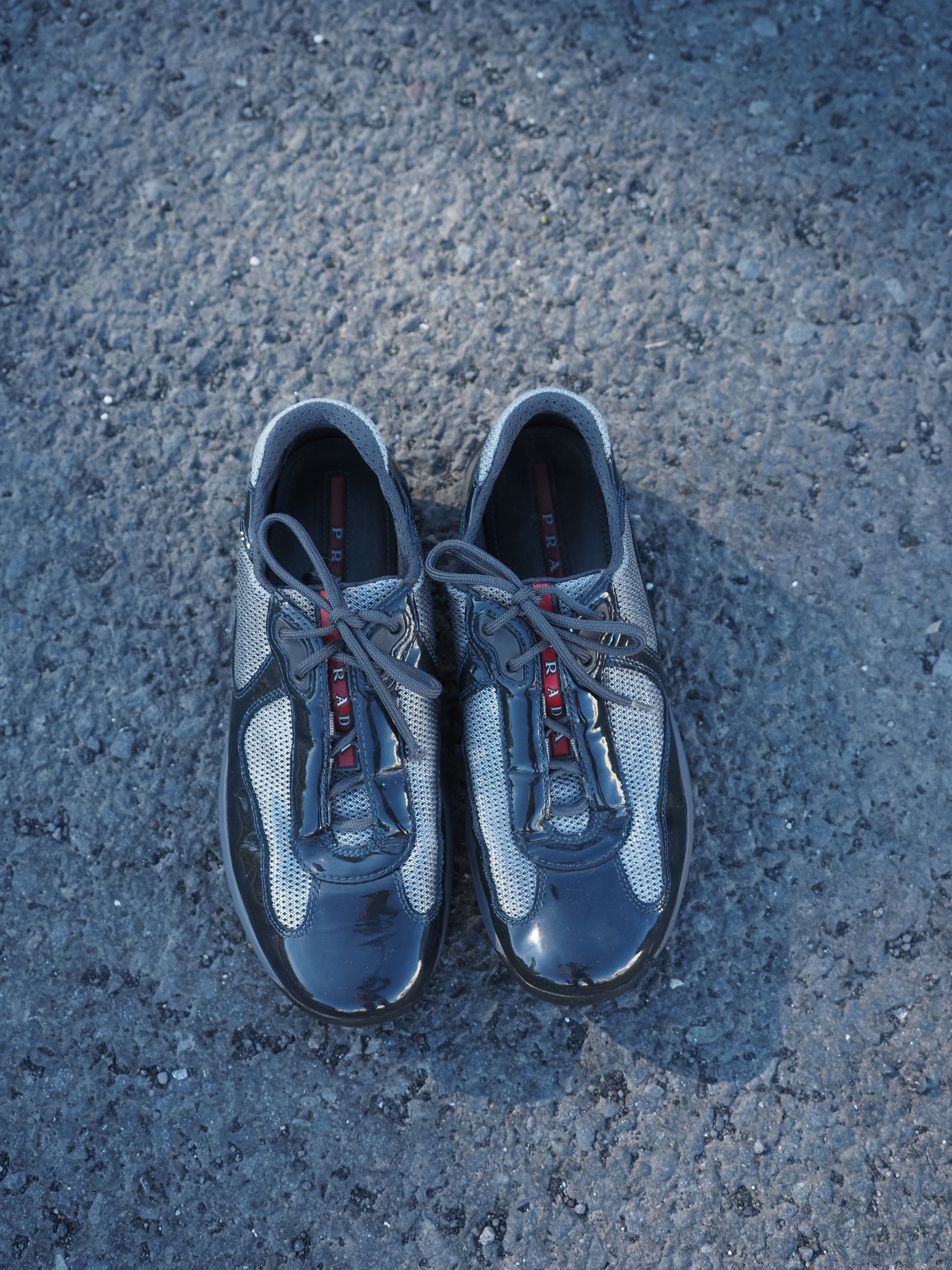 Pair of gray sneakers on a textured surface